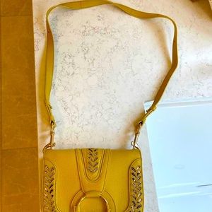 See by chloe mustard yellow with snakes in embossing.